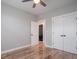 Bedroom with hardwood floors, a ceiling fan, light gray walls, and two closets with black hardware at 1224 Midvale Ave, Charleston, SC 29412