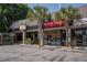 Restaurant exterior with palm trees, prominent signage, outdoor seating, and well-maintained landscaping at 1224 Midvale Ave, Charleston, SC 29412