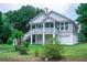 Charming two-story home with a front porch, white stairs, and a well-manicured lawn at 1224 Midvale Ave, Charleston, SC 29412