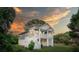 Coastal home with a spacious porch, white railings, stairs, and well-kept lawn, ideal for outdoor living at 1224 Midvale Ave, Charleston, SC 29412
