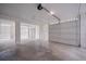 Bright garage with two open doors leading outside, concrete flooring and ceiling lighting at 1224 Midvale Ave, Charleston, SC 29412