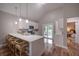 Modern kitchen features white cabinetry, quartz countertops, and a breakfast bar at 1224 Midvale Ave, Charleston, SC 29412