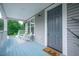 Inviting porch with a hello door mat, rocking chairs, and a view of the surrounding greenery at 1224 Midvale Ave, Charleston, SC 29412