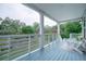 Relaxing porch with painted blue flooring, white chairs, and a view of the green yard at 1224 Midvale Ave, Charleston, SC 29412