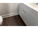 Bathroom vanity boasts white cabinets and dark vinyl flooring at 123 Lewisfield Dr, North Charleston, SC 29418