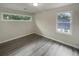 This bedroom is illuminated by two windows and has modern gray vinyl flooring at 123 Lewisfield Dr, North Charleston, SC 29418