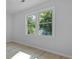 Bright room featuring two windows overlooking mature trees, new paint and modern flooring at 123 Lewisfield Dr, North Charleston, SC 29418