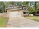 Exterior shot of a two-story home with a well-maintained front yard, garage, and a small front porch at 123 Lewisfield Dr, North Charleston, SC 29418