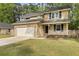 A two-story home featuring a well-manicured lawn, garage, and a charming front porch at 123 Lewisfield Dr, North Charleston, SC 29418