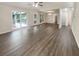 Light-filled living area featuring modern flooring, large windows, and access to the backyard at 123 Lewisfield Dr, North Charleston, SC 29418