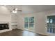Bright living room showcasing a fireplace, built-in shelves, and large windows at 123 Lewisfield Dr, North Charleston, SC 29418