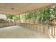 Outdoor patio overlooking a fenced-in backyard with green trees at 123 Lewisfield Dr, North Charleston, SC 29418