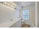 Bright bathroom featuring a white vanity with modern fixtures, complemented by natural light from the window at 125 Eston Dr, Goose Creek, SC 29445