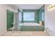 Bathroom featuring green tile, shower and soaking tub at 125 Eston Dr, Goose Creek, SC 29445