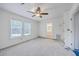 Bright, carpeted bedroom with two windows, ceiling fan, and an ensuite bathroom at 125 Eston Dr, Goose Creek, SC 29445