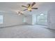 An expansive bedroom featuring neutral carpet, arched window and two ceiling fans at 125 Eston Dr, Goose Creek, SC 29445