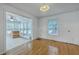 Open dining room with hardwood floors flowing into a sunroom featuring tile floor and lots of windows at 125 Eston Dr, Goose Creek, SC 29445