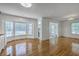 Open-concept space with hardwood floors, bay window, and cabinets ready for installation at 125 Eston Dr, Goose Creek, SC 29445