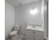 Small powder room with toilet and sink and neutral wall and floor tiling at 125 Eston Dr, Goose Creek, SC 29445