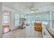Sunroom with multiple windows, tile flooring, and a ceiling fan. Doorway to the house on the left at 125 Eston Dr, Goose Creek, SC 29445