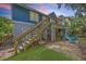 Backyard view of an outdoor patio/tiki bar, fire pit, and staircase to the house at dusk at 13 32Nd Ave, Isle of Palms, SC 29451