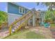 Backyard view of an outdoor patio/tiki bar, fire pit, and staircase to the house at 13 32Nd Ave, Isle of Palms, SC 29451