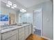 Bright bathroom featuring a double vanity with granite countertop and a separate shower room at 13 32Nd Ave, Isle of Palms, SC 29451