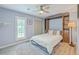 Comfortable bedroom with a Murphy bed, light blue walls, ceiling fan, and built-in shelving at 13 32Nd Ave, Isle of Palms, SC 29451