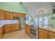 Modern kitchen featuring stainless steel appliances, wooden cabinetry, and granite countertops and island at 13 32Nd Ave, Isle of Palms, SC 29451