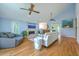 Bright living room with vaulted ceiling, stone fireplace, wood floors and comfortable seating at 13 32Nd Ave, Isle of Palms, SC 29451