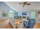 Inviting living room with vaulted ceiling, a stone fireplace, and lots of natural light at 13 32Nd Ave, Isle of Palms, SC 29451