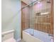 Stylish shower with a wood look wall paneling, a tub, and glass enclosure at 13 32Nd Ave, Isle of Palms, SC 29451