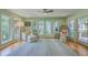 Bright sun room with lots of windows, hardwood floors, neutral decor and comfortable seating at 13 32Nd Ave, Isle of Palms, SC 29451