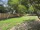 Large backyard has mature trees and lawn, enclosed by a wood fence for privacy at 1317 Wild Olive Dr, Mount Pleasant, SC 29464