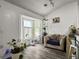 Bright living room featuring a bay window, hardwood floors, and neutral-toned furnishings at 1317 Wild Olive Dr, Mount Pleasant, SC 29464