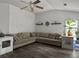 Cozy living room featuring a ceiling fan, hardwood floors, a sectional couch, and several plants at 1317 Wild Olive Dr, Mount Pleasant, SC 29464