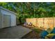 Fenced backyard with a stone patio and seating area, surrounded by lush trees at 1327 Pinnacle Ln, Charleston, SC 29412