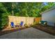 Private backyard features a paved patio with chairs and a well-maintained fence at 1327 Pinnacle Ln, Charleston, SC 29412