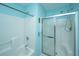 Bright bathroom featuring a shower-tub combo with glass doors and modern fixtures at 1327 Pinnacle Ln, Charleston, SC 29412
