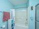 Clean bathroom featuring a shower-tub combo with white shower curtain and convenient storage at 1327 Pinnacle Ln, Charleston, SC 29412