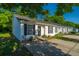 Charming white-sided home with black shutters and a cozy front porch seating area at 1327 Pinnacle Ln, Charleston, SC 29412