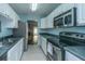 Galley kitchen with white cabinets, stainless steel appliances, and modern countertops at 1327 Pinnacle Ln, Charleston, SC 29412