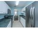 Bright kitchen featuring modern appliances and white cabinetry with view to the dining area at 1327 Pinnacle Ln, Charleston, SC 29412