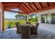 Inviting back porch with views of the bay, rustic furniture and a wood ceiling at 1467 Battalion Dr, James Island, SC 29412