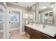 Bathroom featuring double sinks, modern fixtures, decorative pendant lights, and wood cabinetry at 1467 Battalion Dr, James Island, SC 29412