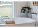 Freestanding bathtub with a scenic view, perfect for relaxation in this modern bathroom retreat at 1467 Battalion Dr, James Island, SC 29412