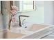 Close-up of a modern bathroom vanity featuring sleek lines, a stylish faucet, and fresh flowers at 1467 Battalion Dr, James Island, SC 29412