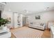 A bright bedroom featuring a white couch, built in mirrored wardrobe, and light wood floors at 1467 Battalion Dr, James Island, SC 29412