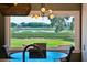 Dining area showcasing waterfront views through a large window, complemented by stylish furnishings at 1467 Battalion Dr, James Island, SC 29412