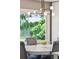 Charming dining area featuring a chandelier, large window overlooking lush greenery, and comfortable seating at 1467 Battalion Dr, James Island, SC 29412